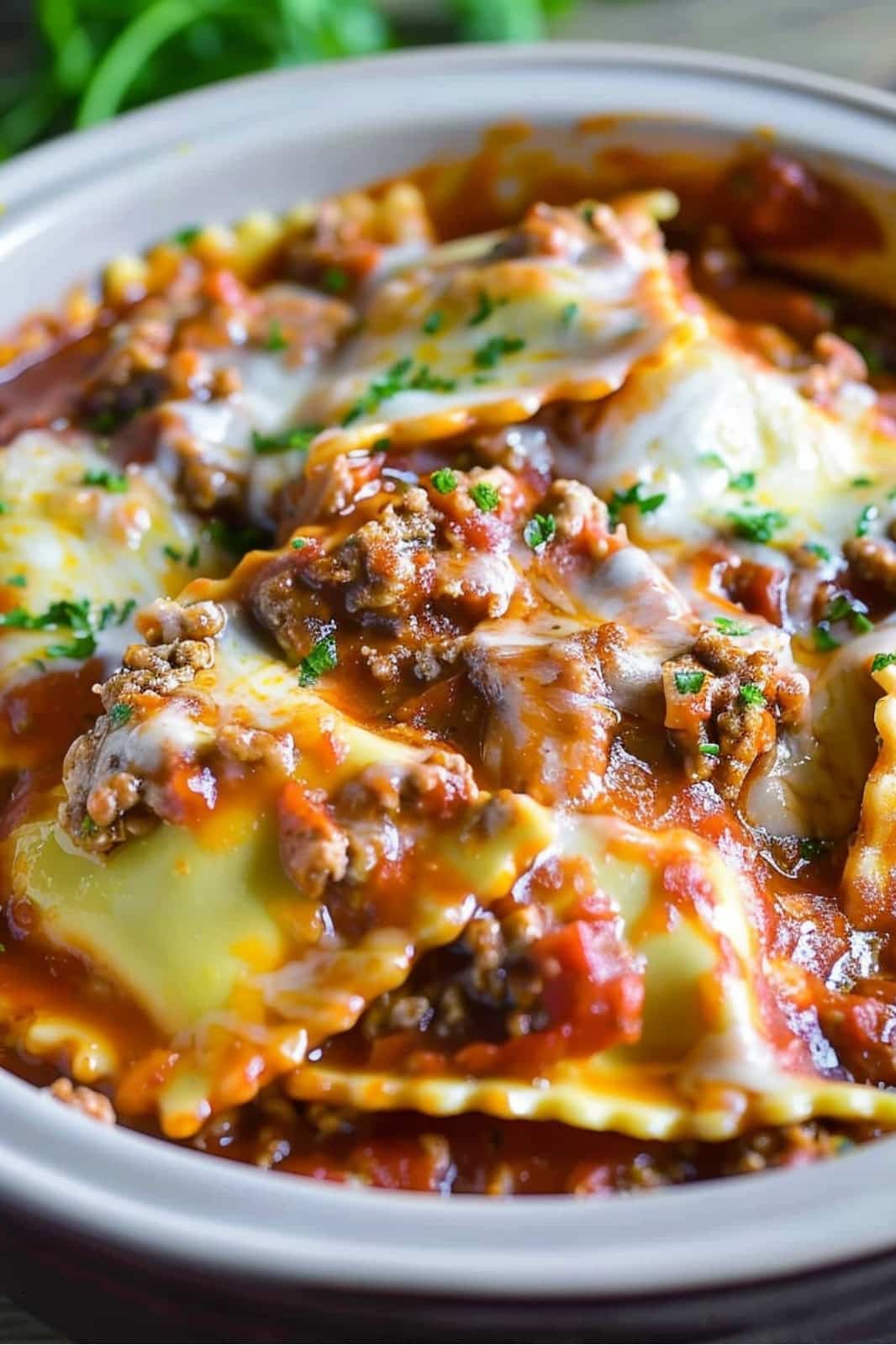 This crockpot ravioli lasagna recipe layers frozen ravioli, ground beef, spaghetti sauce, and mozzarella for a delicious, easy-to-make meal. Perfect for busy weeknights!