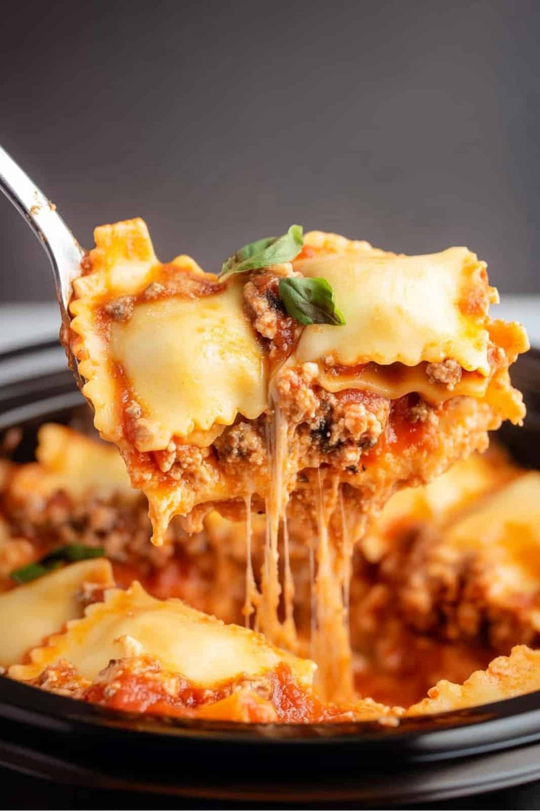 This crockpot ravioli lasagna recipe layers frozen ravioli, ground beef, spaghetti sauce, and mozzarella for a delicious, easy-to-make meal. Perfect for busy weeknights!