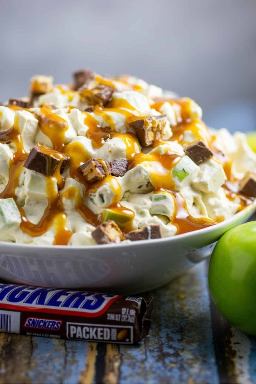 This Caramel Apple Snickers Salad recipe is a quick and easy no-bake dessert! Made with Granny Smith apples, Snickers, and creamy pudding, it's the perfect sweet treat for fall gatherings.