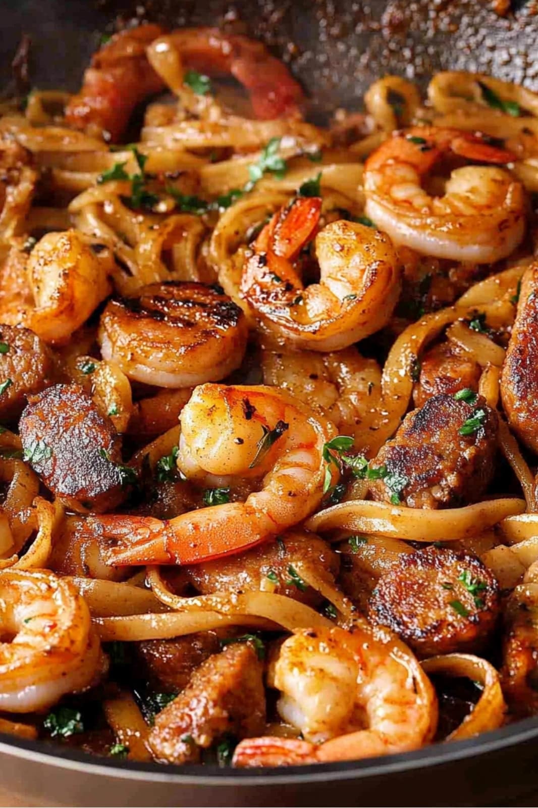 This Creamy Cajun Shrimp Pasta with Sausage recipe is a deliciously spicy dish! Fettuccine pasta, shrimp, and sausage in a creamy Cajun sauce make for a perfect weeknight meal.