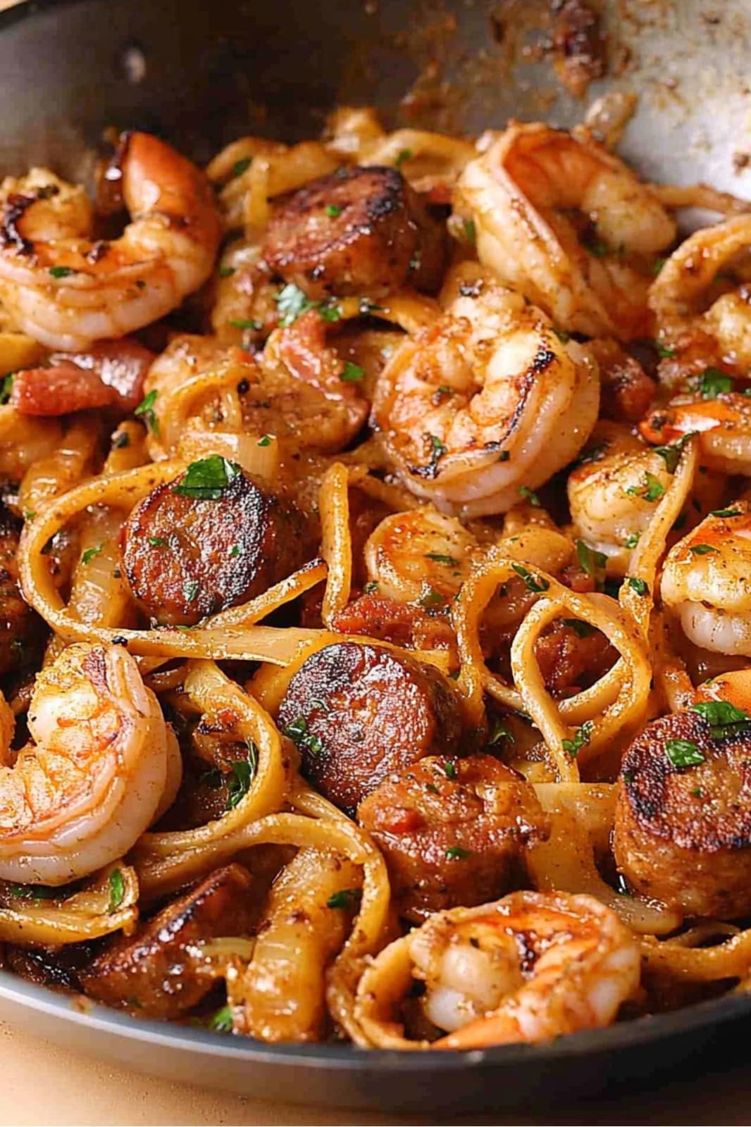 This Creamy Cajun Shrimp Pasta with Sausage recipe is a deliciously spicy dish! Fettuccine pasta, shrimp, and sausage in a creamy Cajun sauce make for a perfect weeknight meal.