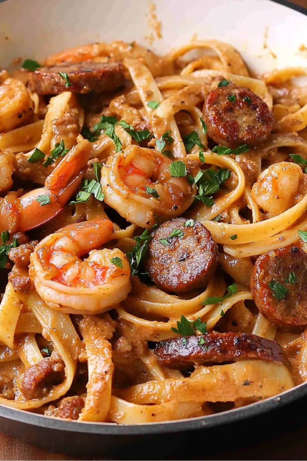 This Creamy Cajun Shrimp Pasta with Sausage recipe is a deliciously spicy dish! Fettuccine pasta, shrimp, and sausage in a creamy Cajun sauce make for a perfect weeknight meal.