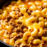 A comforting bowl of macaroni pasta with melted cheese and ground beef, served in a creamy sauce reminiscent of an easy cheeseburger soup.