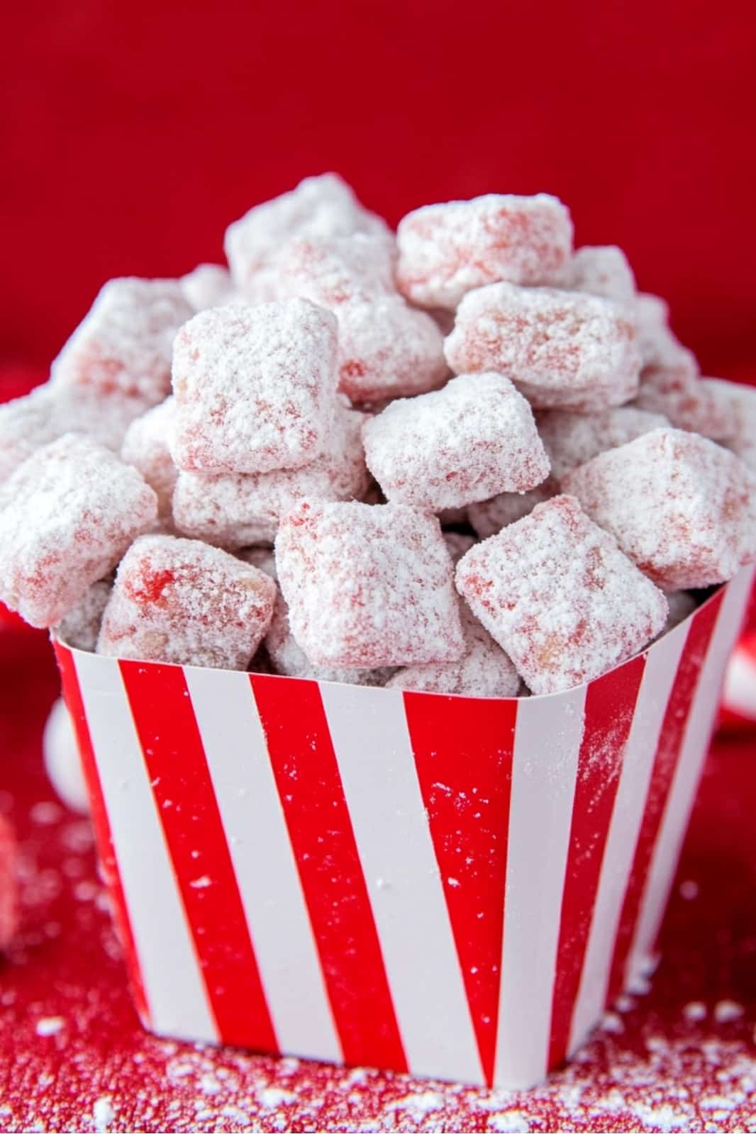 This Candy Cane Peppermint Puppy Chow recipe is a festive holiday treat! Chex cereal coated in peppermint baking chips, powdered sugar, and crushed candy canes makes a perfect Christmas snack.