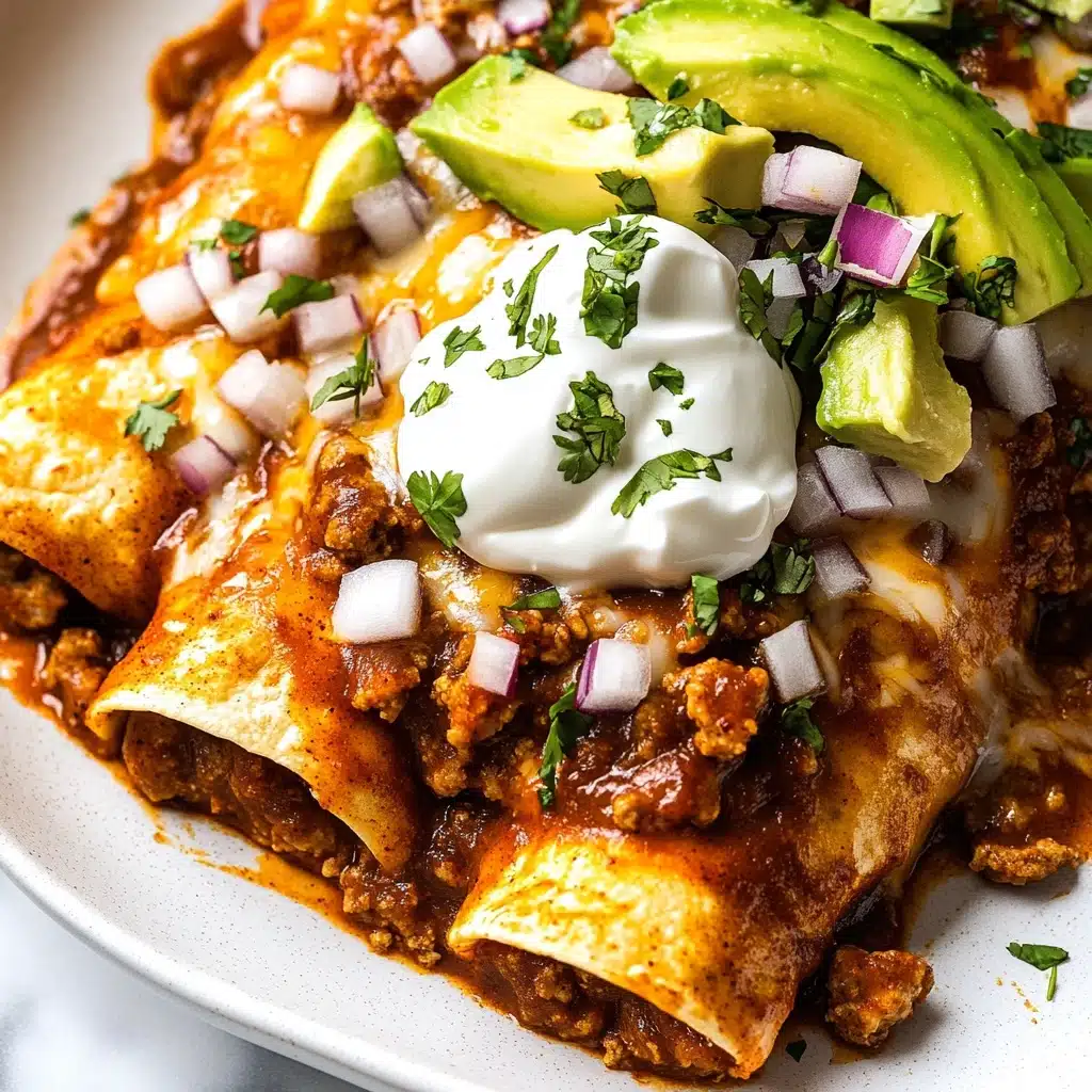 Beef Enchiladas with Green Chiles and Pinto Beans, Mexican Beef Enchiladas, Green Chile Enchiladas, Pinto Bean Enchiladas, Easy Beef Enchilada Recipe A close-up of enchiladas on a white plate, featuring golden brown tortillas covered in a rich, reddish-brown sauce sitting on top. The top layer is adorned with sliced bright green avocado, a dollop of creamy white sour cream, crumbly white cheese, and sprinkled with chopped fresh green cilantro and small cubes of purple onion. The enchiladas are slightly open, showing a thick, chunky filling of ground meat, beans, and melted cheese inside, mixing brown and beige tones. The background is a white marbled texture.