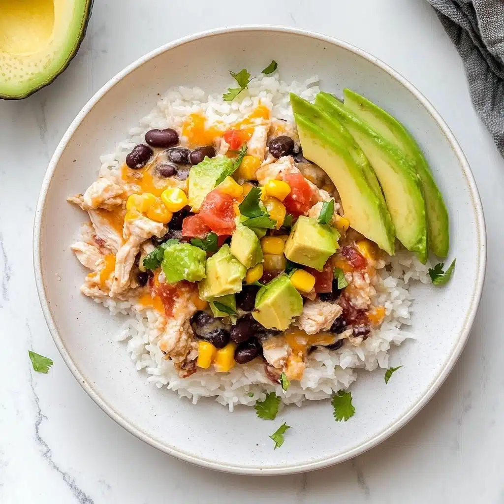 Mexican Chicken Casserole, easy Mexican dinner, cheesy chicken casserole, flavorful Mexican recipes, weeknight Mexican casserole A rectangular white casserole dish holds a layered bake with a base of fluffy white rice topped by chunks of meat, all covered with a colorful blend of yellow corn, black beans, diced red tomatoes, and melted cheese that is slightly golden on the edges. The top looks rich and textured, with melted cheese gluing together the black beans and corn, while the edges show some browning from baking. Green herb bits are sprinkled over the top for color. Sliced avocado fans are placed in two corners for decoration. A woman's hand is holding a black spoon, scooping a portion to reveal the layers. The dish sits on a white marbled texture background.