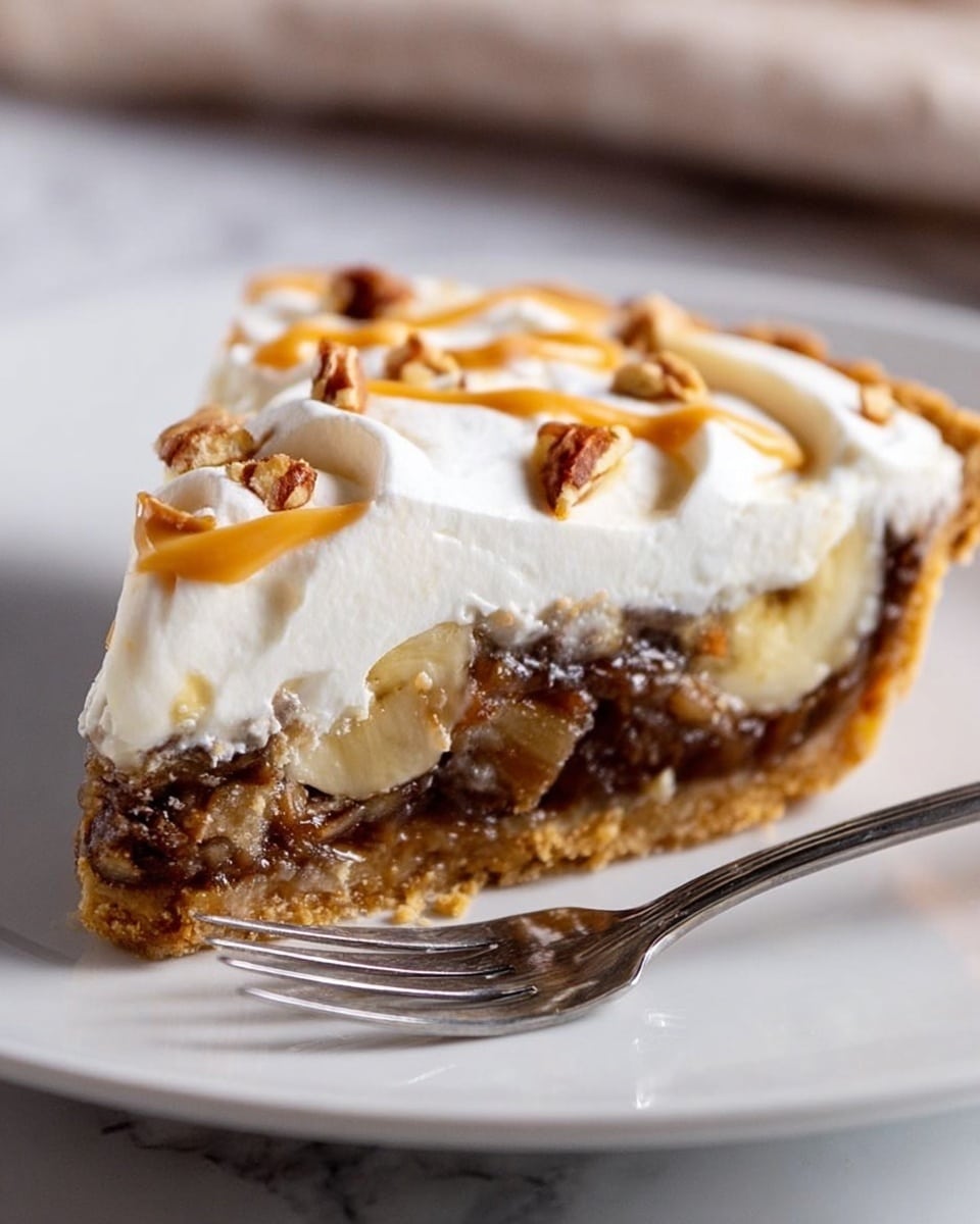 A slice of pie on a white plate with a white marbled background. The bottom layer is golden brown and crumbly crust. Above the crust is a thick, dark brown gooey layer mixed with nuts. Next is a lighter brown layer with soft, slightly translucent pieces that look like banana slices. The top layer is thick white whipped cream, swirled with light brown caramel sauce and dotted with small pieces of nuts. A silver fork is placed on the plate next to the pie slice. Photo taken with an iphone --ar 4:5 --v 7