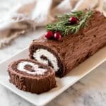 Buche de Noel: Classic Chocolate Yule Log with Creamy Filling and Festive Garnishes Recipe