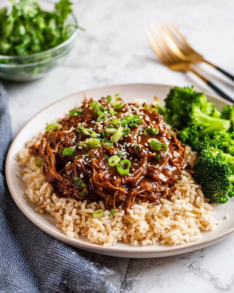 The dish shows three main layers on a white plate with a white marbled surface under it. The bottom layer is a bed of light brown cooked rice with a soft texture that covers most of the plate. On top of the rice, there is a thick layer of dark brown shredded meat covered in a glossy sauce, sprinkled with white sesame seeds and finely chopped green onions scattered on top. To the right side of the plate, there is a small bunch of bright green steamed broccoli with a slightly shiny texture. In the background, there is a glass bowl with green leafy herbs and a gold-colored fork resting on the white marbled surface. Photo taken with an iphone --ar 4:5 --v 7