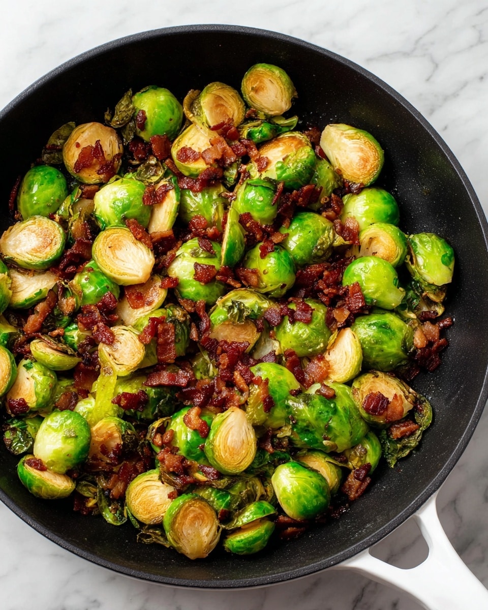 A black skillet filled with cooked Brussels sprouts and small pieces of crispy bacon. The Brussels sprouts are halved, showing bright green and golden-brown layers with a slightly charred texture. The bacon bits are deep reddish-brown and scattered evenly on top and between the sprouts, adding a crunchy texture contrast. The skillet is placed on a white marbled surface, and the white handle of the skillet is visible on the right side. Photo taken with an iphone --ar 4:5 --v 7