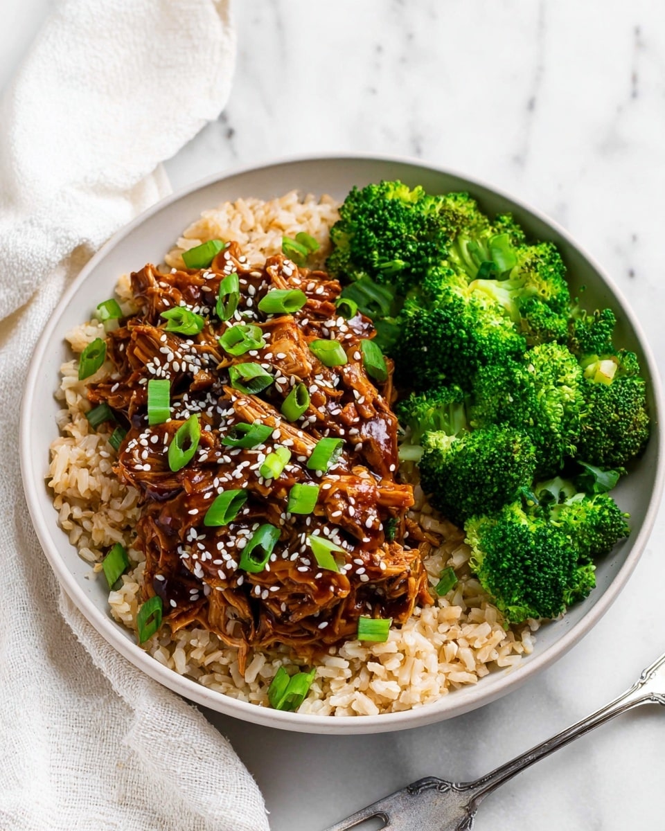 The image shows a white round plate with three main layers of food arranged separately. The bottom layer is light brown rice spread across the plate. On the left side, over the rice, there is shredded dark brown chicken coated in a shiny sauce, sprinkled with white sesame seeds and chopped green onions for garnish. On the right side, there are vibrant green steamed broccoli florets. The background has a white marbled texture with a soft white cloth nearby. A silver fork rests on the edge of the plate. Photo taken with an iphone --ar 4:5 --v 7