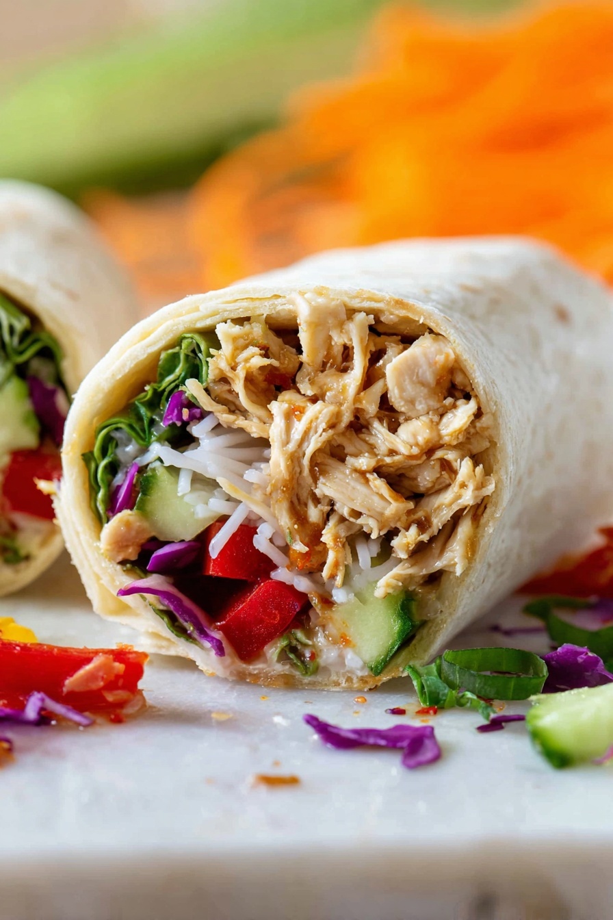 A white tortilla lays flat on a white marbled surface with visible layers of food on top, starting with thin white noodles at the base. Above the noodles, there is a layer of golden brown cooked chicken pieces, followed by thin orange carrot strips and bright purple cabbage slices. Fresh green herbs, green onion slices, and a red chili pepper are placed on top, creating a colorful and fresh look. In the blurred background, there is a white can with blue and green text and some orange shredded vegetables. Photo taken with an iphone --ar 2:3 --v 7 - Chicken Teriyaki Wraps, Asian-inspired chicken wraps, quick dinner recipes, healthy lunch ideas, flavorful chicken wraps