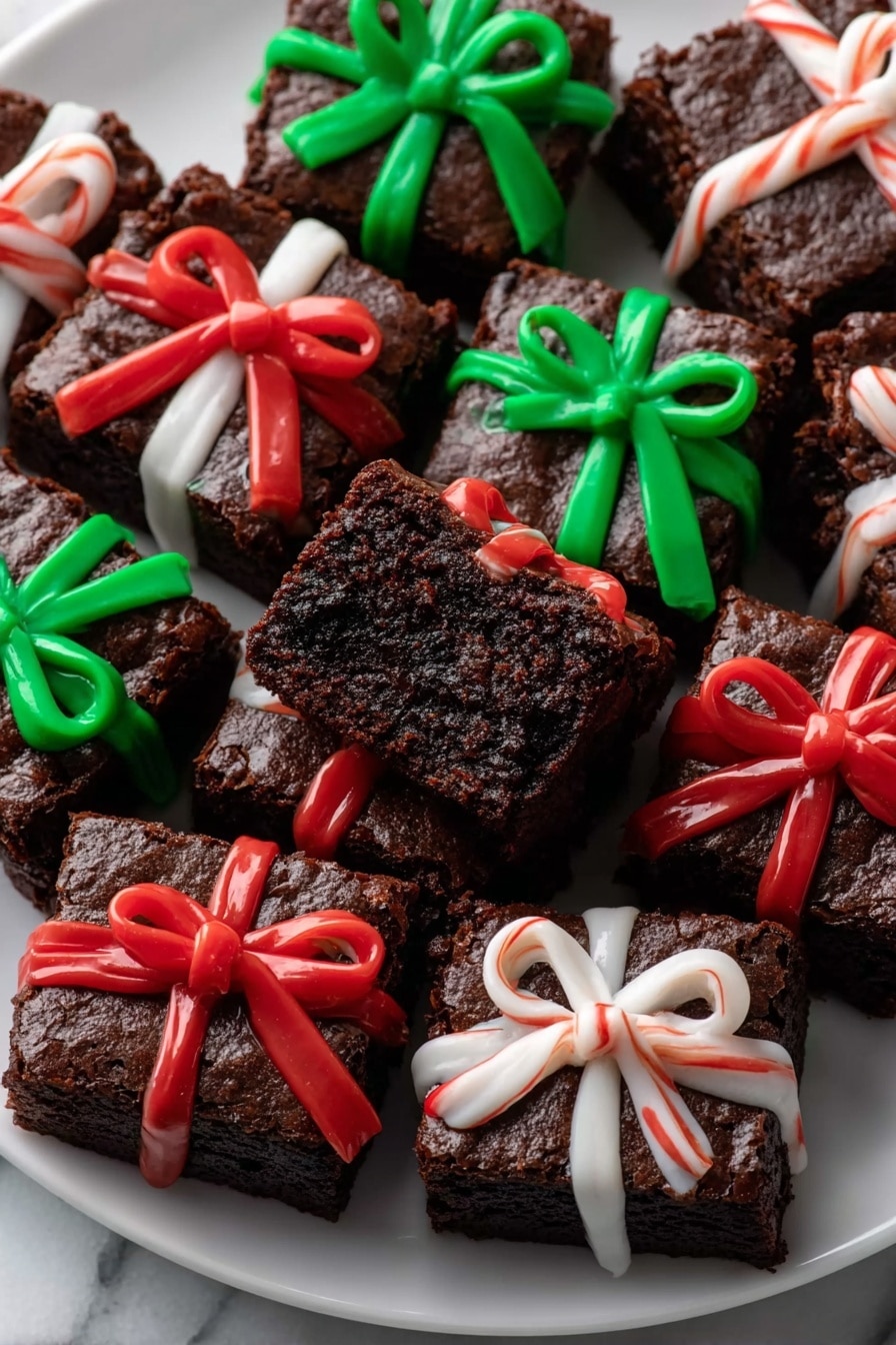 Square pieces of rich, dark brown brownie are arranged closely together on a white plate, each decorated like a small gift box. On top of each brownie, there are smooth, shiny icing ribbons in bright red, green, and white, with some tied into bows while others look like simple crossed stripes. One brownie near the center is turned sideways showing its dense, moist texture inside. The plate sits on a white marbled surface, and the overall look is festive and colorful with the vibrant ribbons standing out against the dark brownies. photo taken with an iphone --ar 2:3 --v 7 - Christmas Present Fudge Brownies, festive brownie ideas, holiday dessert recipes, Christmas gift treats, fudge brownie decorations