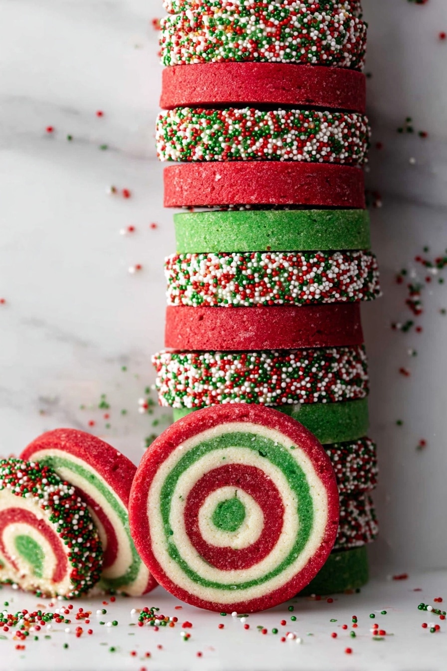 Christmas Pinwheel Cookies Recipe 8 The image shows a stack of round swirl cookies with three colors in each cookie: red on the outside, a green spiral in the middle, and a white layer between them. The edges of the cookies are covered in small red, green, and white round sprinkles, some of which have scattered on the white marbled surface below. The cookies are neatly stacked vertically in the center with a few lying flat around the base. The overall look is festive and bright with clear contrast between the layers. Photo taken with an iphone --ar 2:3 --v 7 - Christmas Pinwheel Cookies, festive cookie recipes, holiday sugar cookies, colorful swirl cookies, easy Christmas baking