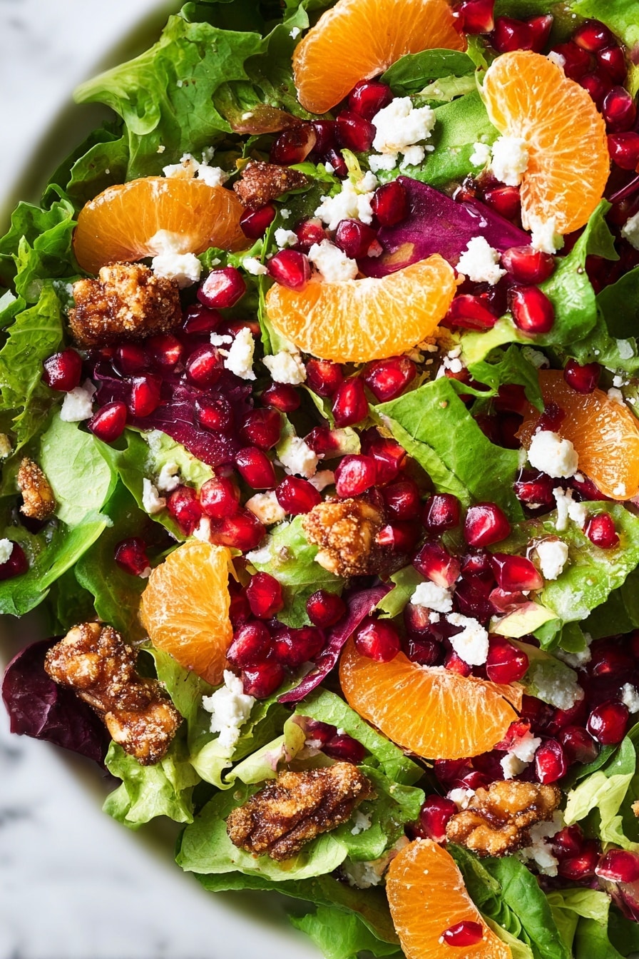 Festive Orange Pomegranate Salad Recipe 6 A fresh salad with several layers is shown on a white marbled surface. The bottom layer is made of leafy greens in different shades of green and dark purple with soft textures. On top of this, there are bright orange tangerine slices spread around. Scattered across the salad are glossy, deep red pomegranate seeds adding shine and color contrast. Light brown, crunchy-looking coated nuts are placed evenly over the salad. Small white pieces of crumbly cheese dot the top layer, giving a creamy texture and color contrast. The whole dish looks colorful and fresh with a mix of soft, crunchy, and juicy textures. Photo taken with an iphone --ar 2:3 --v 7 - Festive Orange Pomegranate Salad, holiday citrus salad, easy fruity salad, colorful holiday salad, citrus pomegranate fruit salad