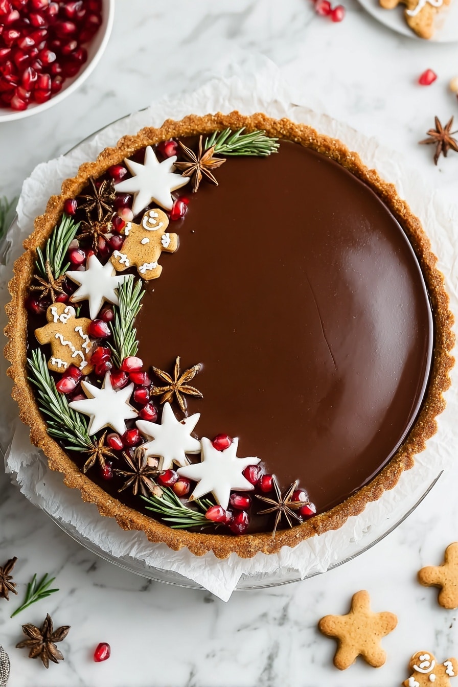 Vegan Gingerbread Chocolate Tart Recipe 6 This image shows a round tart with a smooth, shiny chocolate filling, having a golden-brown crust around the edges. The tart is decorated on one side with various small items: white star-shaped cookies with a smooth icing layer, small gingerbread men cookies with white icing details, bright red pomegranate seeds, green rosemary sprigs, and brown star anise pods. The decorations form a thick curved line along one edge of the tart. The tart sits on a white paper on top of a clear glass plate, all placed on a white marbled surface. Nearby, more star-shaped cookies and pomegranate pieces are scattered lightly. Photo taken with an iphone --ar 2:3 --v 7 - Vegan Gingerbread Chocolate Tart, Festive vegan desserts, Holiday chocolate tart, Vegan gingerbread dessert, Easy vegan holiday dessert