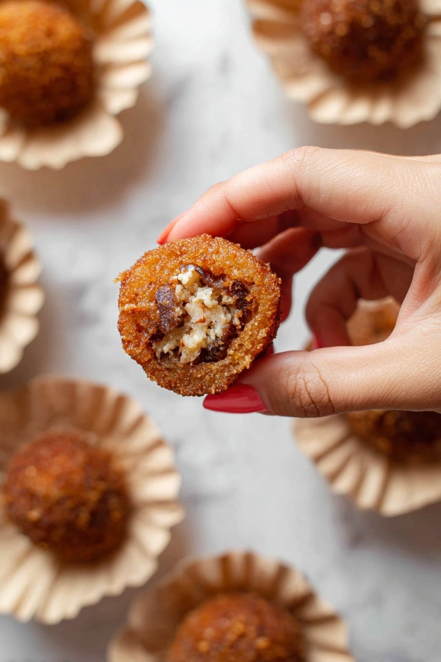 Authentic Pani Puri Recipe 6 A close-up of a woman's hand holding a small round fried snack with a crispy brown outer shell that is textured and thin. Inside the snack is a filling with visible white and dark brown chunks, appearing soft and crumbly. The snack is held above white paper bowls that hold more of the same items, placed on a white marbled surface. The bowls have a gathered edge and the snacks in them look similar in color and texture to the one held. photo taken with an iphone --ar 2:3 --v 7 - Authentic Pani Puri, Pani Puri Recipe, Indian street food, how to make Pani Puri, beginner Pani Puri