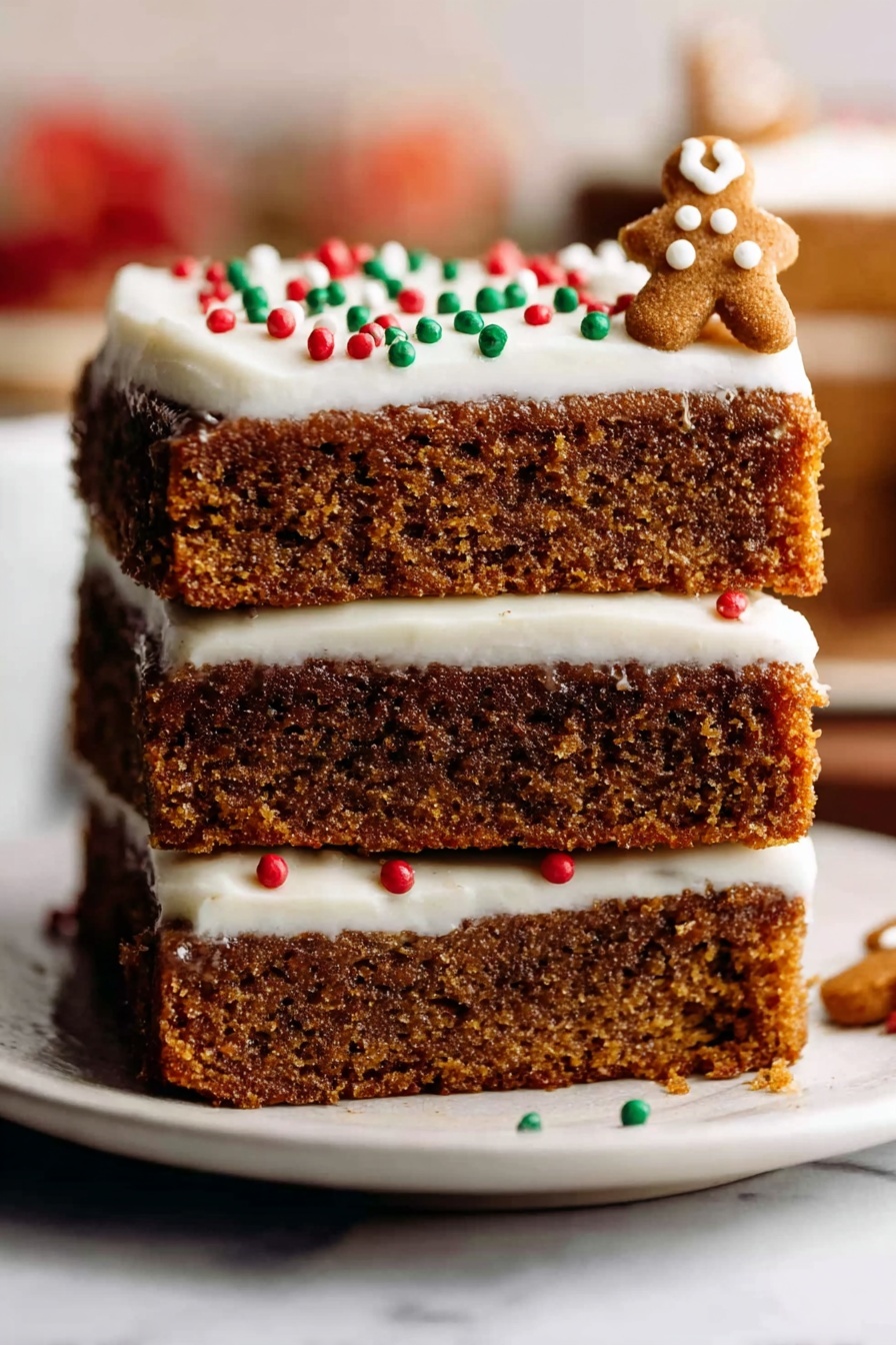 Gingerbread Cookie Bars with Cream Cheese Frosting Recipe 8 A stack of three thick, soft brown cake layers with a moist texture sits on a white plate placed on a white marbled surface. The top layer is covered with smooth white frosting, decorated with small round red, green, and white sprinkles, and a few small gingerbread-shaped decorations on the right side. The background is blurred with warm colors, making the cake the clear focus. photo taken with an iphone --ar 2:3 --v 7 - Gingerbread Cookie Bars with Cream Cheese Frosting, gingerbread cookie bars, holiday gingerbread bars, easy gingerbread dessert, festive cookie bars