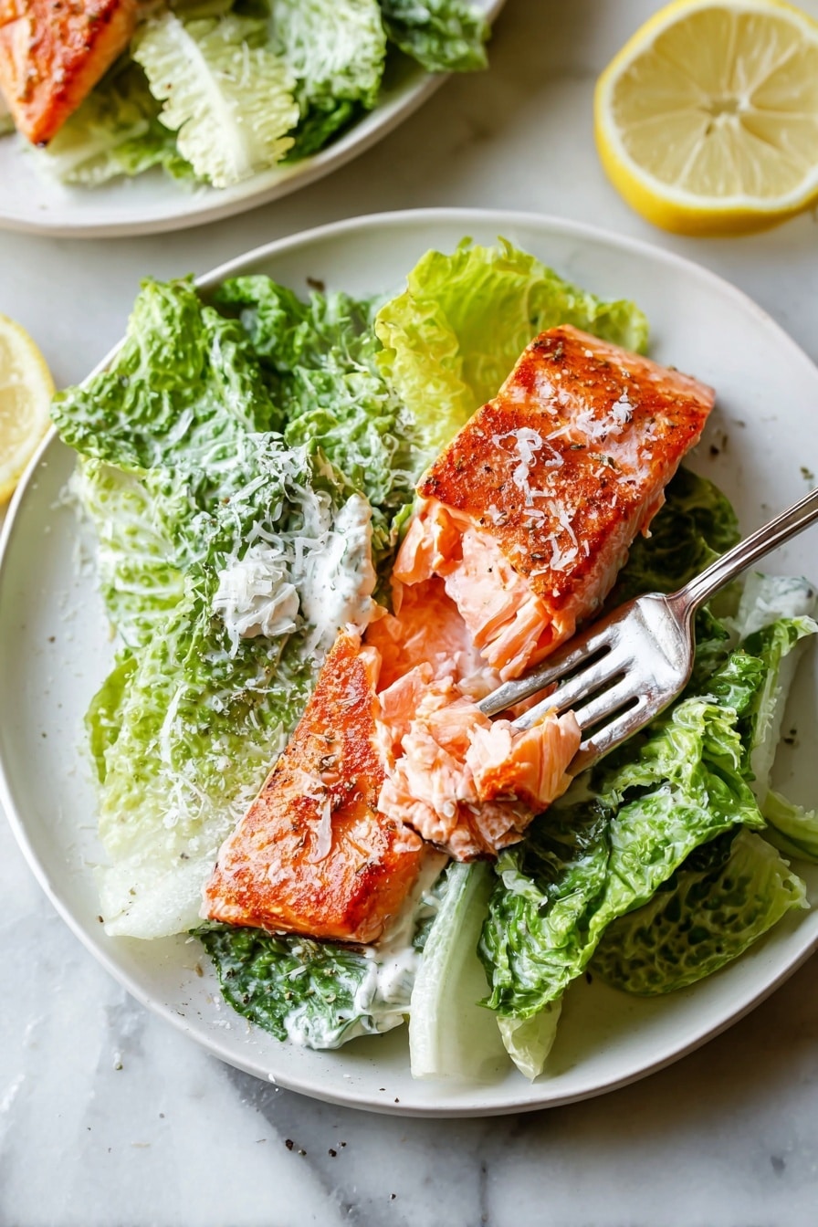 Salmon Caesar Salad Recipe 6 A white plate is filled with three main layers: at the bottom, a bed of green romaine lettuce leaves with a creamy white dressing, sprinkled lightly with grated cheese; on top of the lettuce lies a thick piece of cooked salmon with a bright orange, slightly crispy skin and moist, flaky flesh being gently separated by a silver fork; the plate sits on a white marbled surface with a few lemon slices nearby. photo taken with an iphone --ar 2:3 --v 7 - Salmon Caesar Salad, healthy salmon salad, easy salmon salad recipe, quick Caesar salad with salmon, flavorful seafood salads
