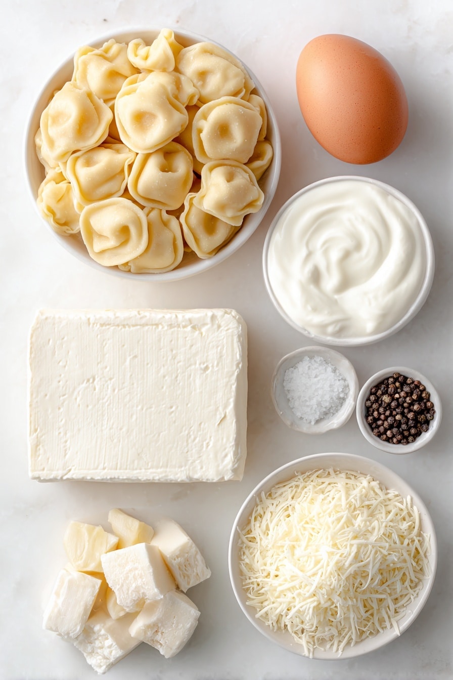 Cheese Tortellini Alfredo Bake Recipe 7 Flat lay of fresh cheese tortellini arranged loosely, a small white bowl of golden butter cubes, three peeled garlic cloves, a square of softened cream cheese resting on a white ceramic plate, a small white bowl filled with rich heavy cream, a small white bowl piled with freshly grated parmesan cheese, a small white bowl of shredded mozzarella cheese, one whole uncracked brown egg, a small white bowl containing coarse sea salt, a small white bowl holding cracked black peppercorns, all ingredients placed symmetrically on a clean white marble surface, soft natural light, photo taken with an iPhone, professional food photography style, fresh ingredients, white ceramic bowls, no bottles, no duplicates, no utensils, no packaging --ar 2:3 --v 7 --p m7354615311229779997 - Cheese Tortellini Alfredo Bake, creamy baked pasta, cheesy tortellini casserole, easy pasta dinner, comforting cheesy pasta dish