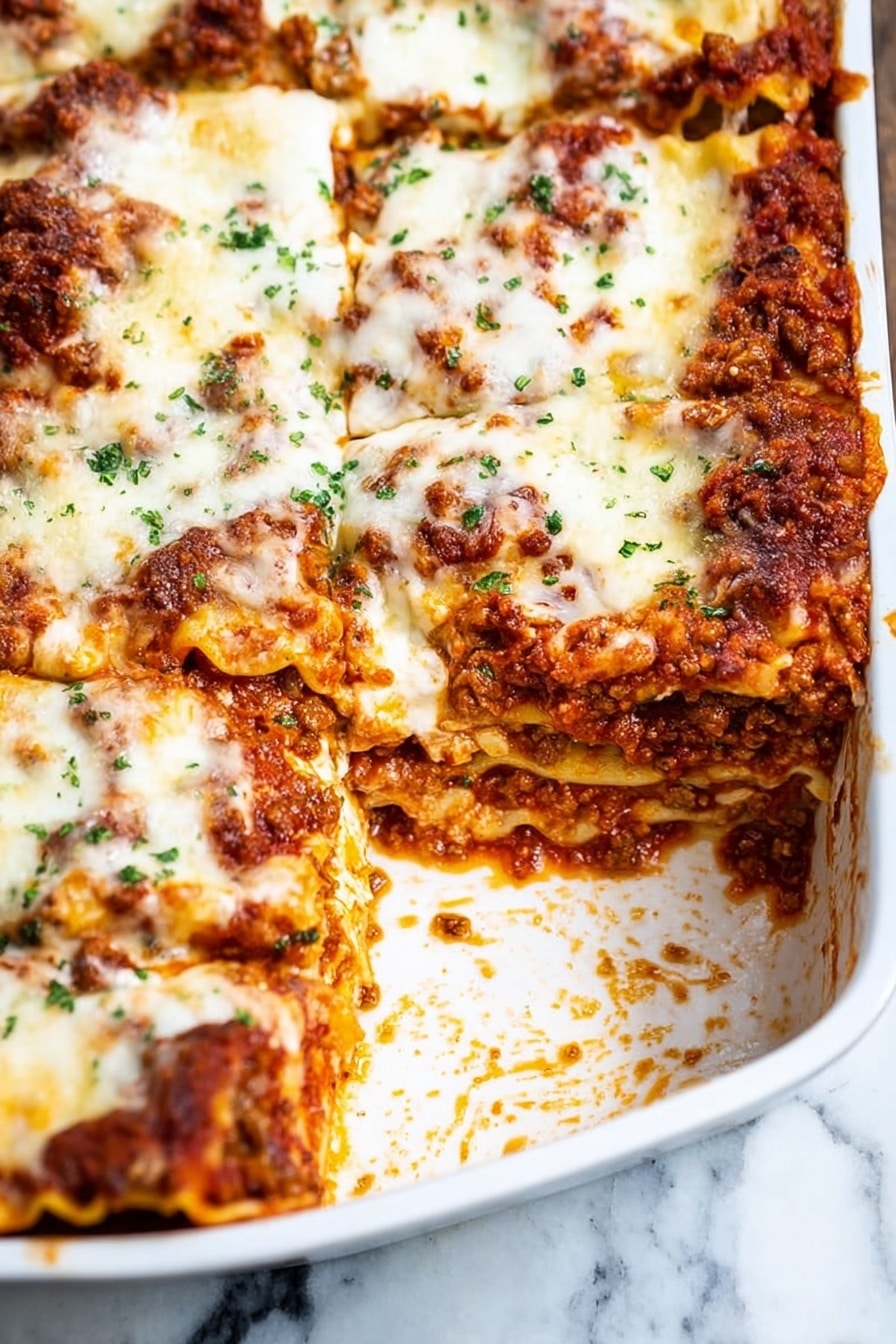 Homemade Italian Sausage Lasagna Recipe 8 The image shows a close-up of a white rectangular baking dish holding a layered lasagna. The lasagna has several layers: at the bottom are flat pasta sheets, followed by a thick layer of cooked ground meat mixed with a rich red tomato sauce, then a generous layer of melted cheese that is light golden with browned spots. The top layer consists mostly of melted white cheese with some toasted light brown patches and small green herbs sprinkled over it. One piece of the lasagna has been removed from the corner, showing all the thick layers inside. The dish sits on a white marbled surface with some sauce spills around the empty corner. photo taken with an iphone --ar 2:3 --v 7 - Homemade Italian Sausage Lasagna, Italian sausage lasagna, hearty lasagna recipe, cheesy lasagna with sausage, easy Italian dinner