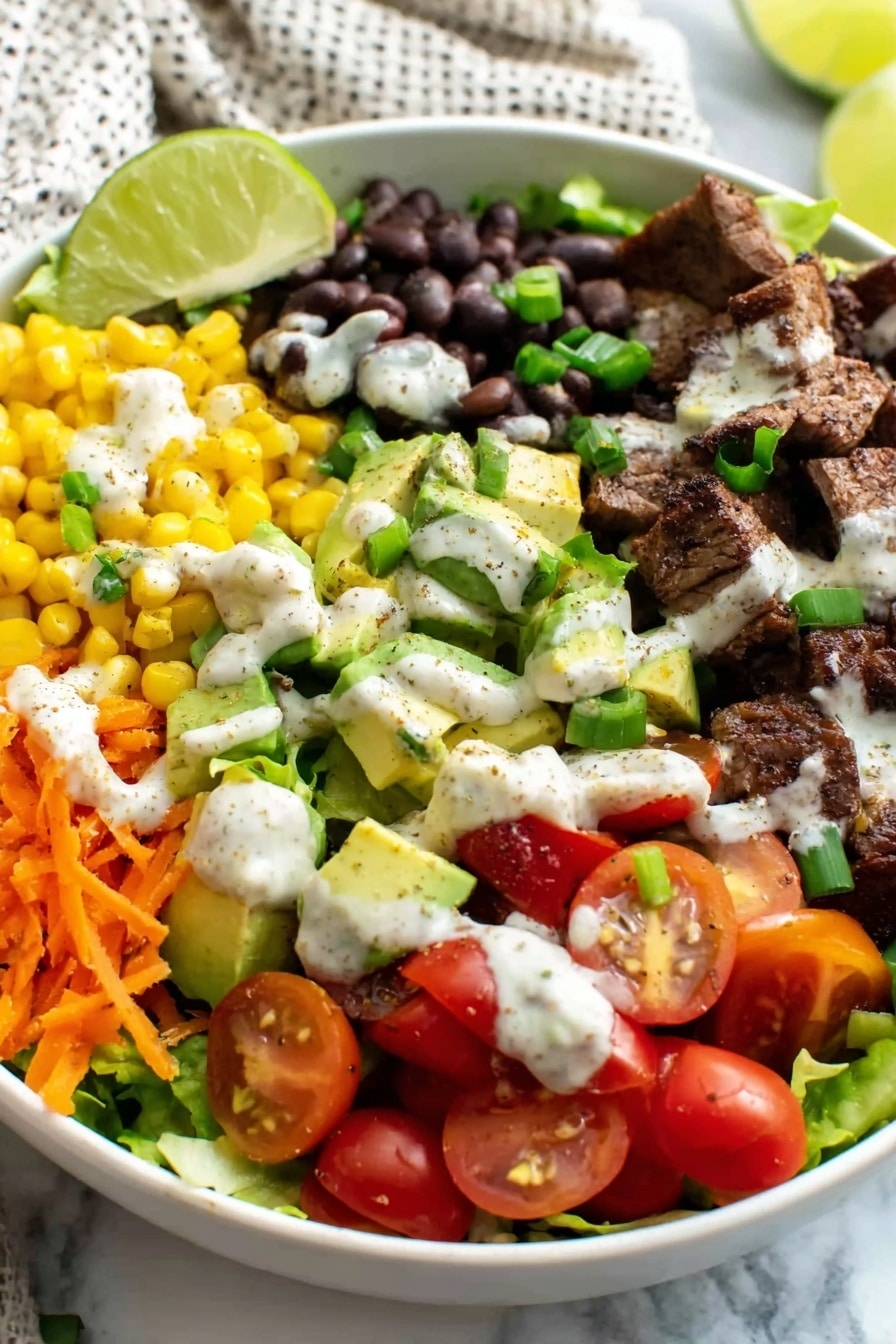 Southwest Steak Salad with Chili Lime Chicken Recipe 8 The white bowl holds a colorful layered salad arranged in sections: bright yellow corn kernels, glossy black beans, and diced green avocado chunks each topped with creamy white dressing sprinkled with tiny spices. There is grated orange carrot and halved red cherry tomatoes on a bed of fresh green lettuce leaves. Dark grilled meat pieces lie alongside the vegetables, all garnished with chopped green onions. A wedge of light green lime rests near the top edge. The bowl is set on a white marbled surface with a light patterned cloth in the background. Photo taken with an iphone --ar 2:3 --v 7 - Southwest Steak Salad with Chili Lime Chicken, chili lime chicken recipe, Southwest steak salad, spicy chicken salad, healthy steak salad
