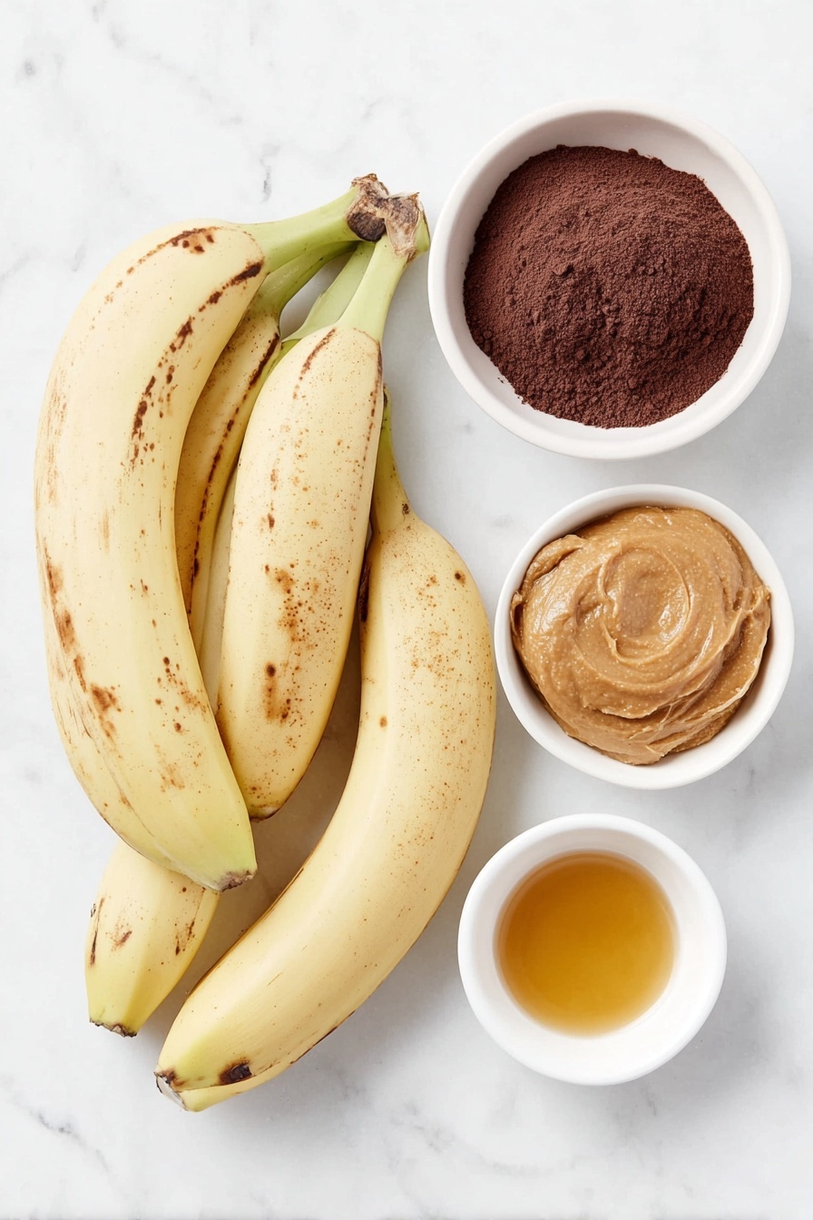 Banana Peanut Butter Brownies Recipe 7 Flat lay of three medium overripe bananas with a few brown spots, a small white ceramic bowl filled with smooth peanut butter, a small white ceramic bowl containing fine unsweetened cocoa powder, and a small white ceramic bowl holding golden maple syrup, all arranged symmetrically with balanced spacing, placed on a clean white marble surface, soft natural light, photo taken with an iPhone, professional food photography style, fresh ingredients, white ceramic bowls, no bottles, no duplicates, no utensils, no packaging --ar 2:3 --v 7 --p m7354615311229779997 - Banana Peanut Butter Brownies, healthy brownie recipe, egg-free chocolate brownies, gluten-free dessert, easy chocolate banana treats