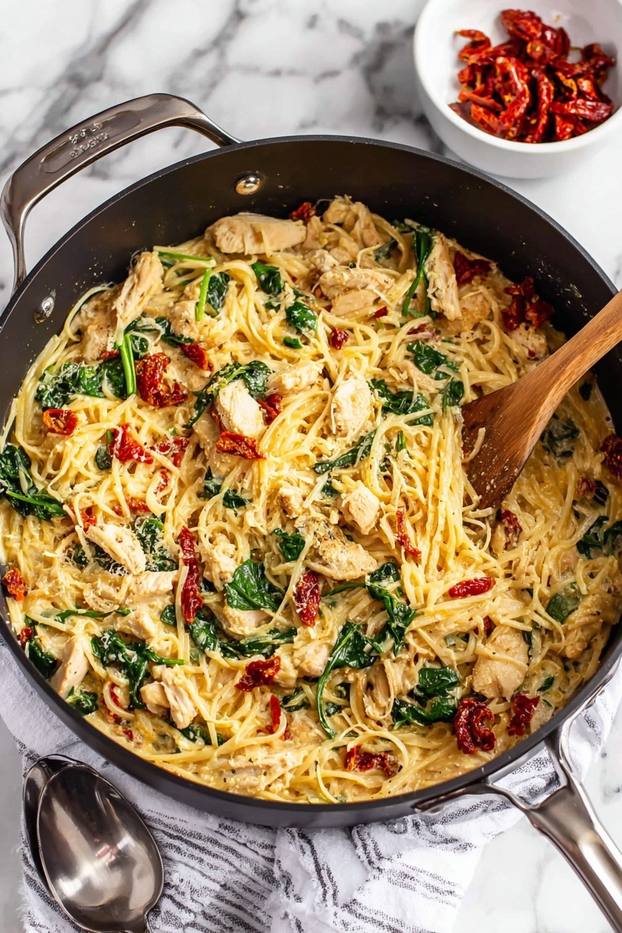 Tuscan Chicken with Spaghetti Squash Recipe 8 A black pan filled with one main layer of creamy pasta mixed with light golden strands of cheese, pieces of white and lightly browned chicken, scattered bright green spinach leaves, and small chunks of red sun-dried tomatoes, all stirred by a wooden spoon on the right side; the pan sits on a white marbled surface with a white and black striped cloth beneath it, next to a small white bowl containing more red sun-dried tomatoes and a silver spoon; photo taken with an iphone --ar 2:3 --v 7 - Tuscan Chicken with Spaghetti Squash, healthy Tuscan chicken dinner, light Italian chicken recipes, quick weeknight chicken dishes, low-carb spaghetti squash recipes
